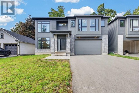 A modern two-story house with a garage is for sale.
