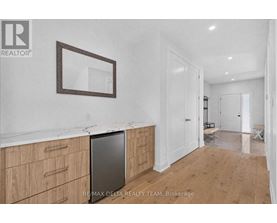 A kitchen with wooden cabinets and a fridge.