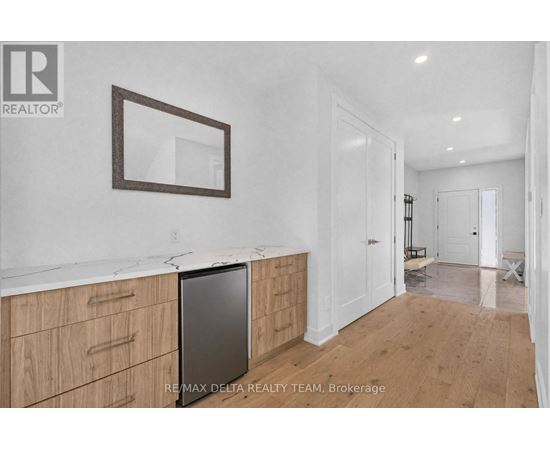 A kitchen with wooden cabinets and a fridge.