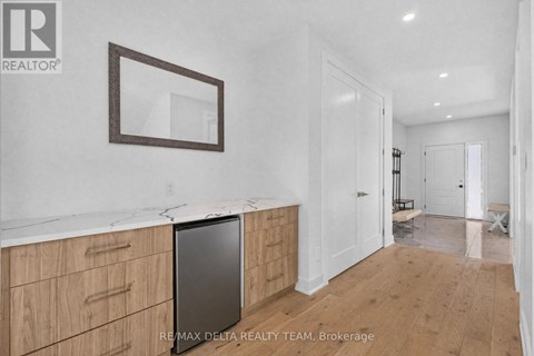 A kitchen with wooden cabinets and a fridge.