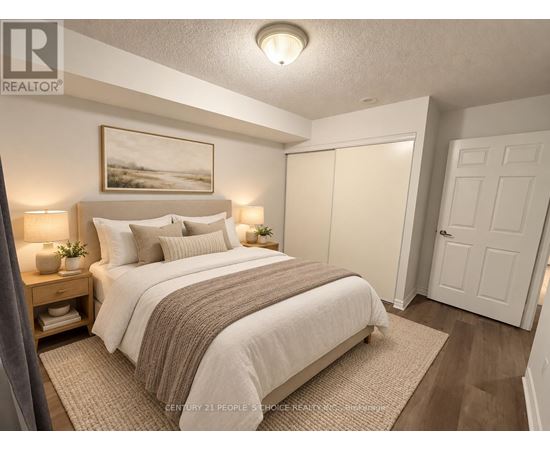 A bedroom with a large bed and a painting on the wall.