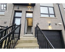 A building with a black railing and a door with a number 4 on it.