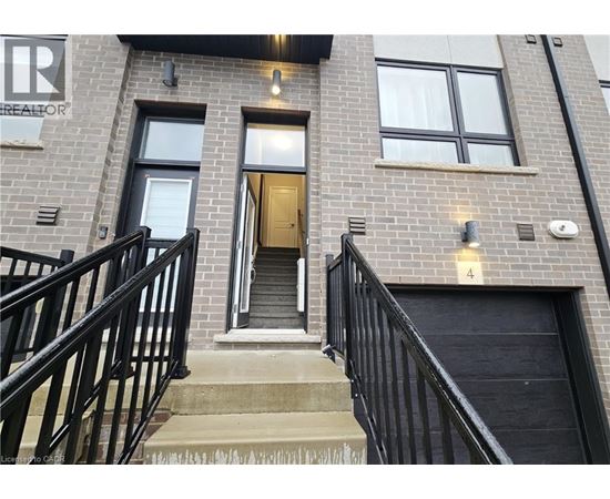 A building with a black railing and a door with a number 4 on it.