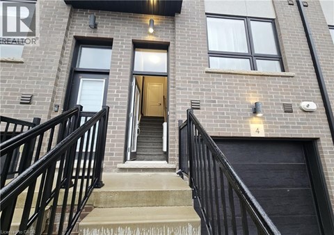 A building with a black railing and a door with a number 4 on it.