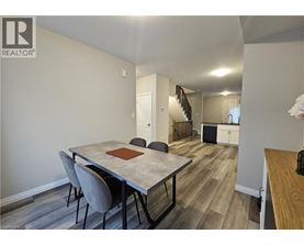 A dining room with a table and chairs.