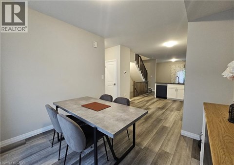 A dining room with a table and chairs.
