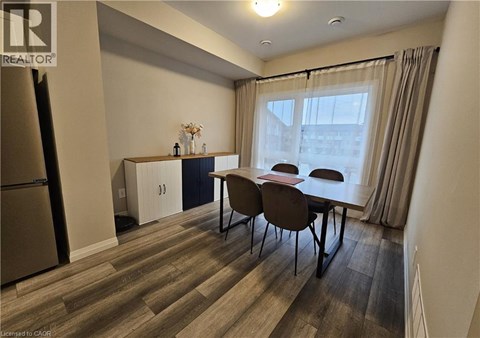 A dining area with a table and chairs is shown.