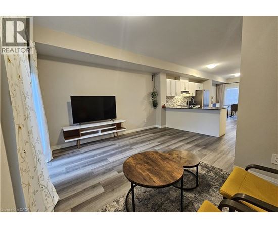 A living room with a television and a wooden table.