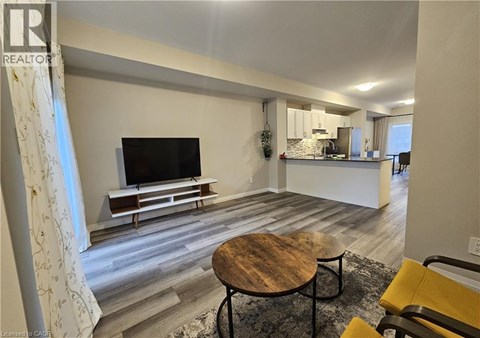 A living room with a television and a wooden table.