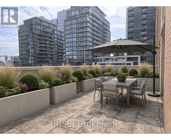 A patio with a table and chairs overlooks a cityscape.