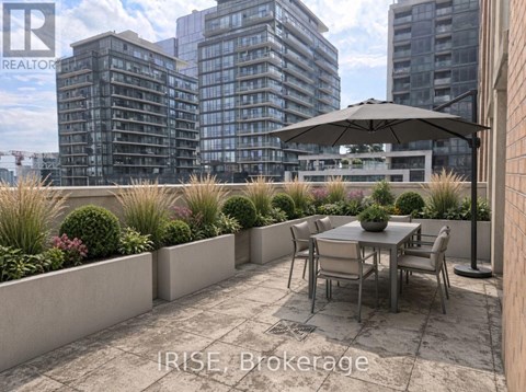 A patio with a table and chairs overlooks a cityscape.
