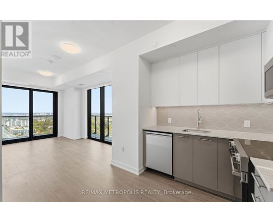 A kitchen with white cabinets and a dishwasher.