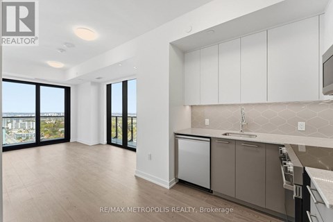 A kitchen with white cabinets and a dishwasher.