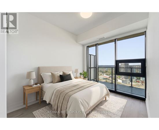 A bedroom with a large bed and a view of the city.