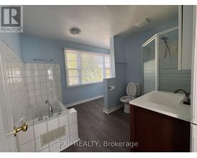 A bathroom with a toilet, sink, and bathtub.