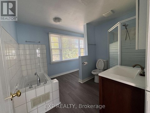 A bathroom with a toilet, sink, and bathtub.