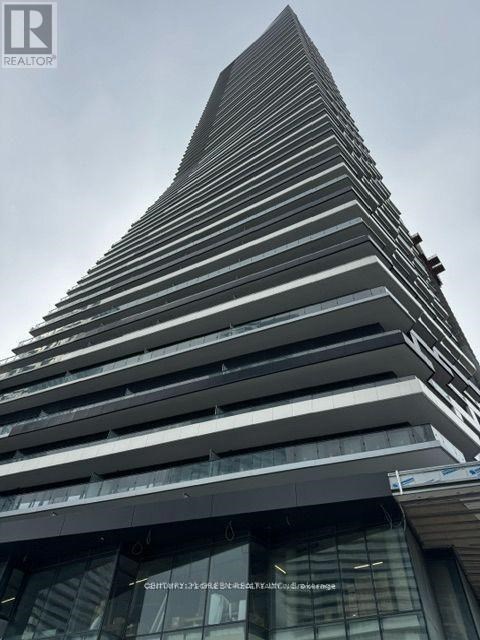 A tall building with a pointed top and a sign that says "REALTOR".