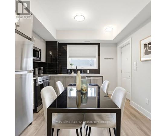 A modern kitchen with a dining table set for four.
