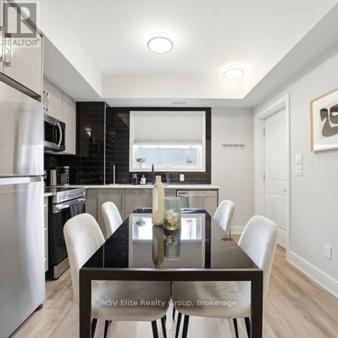 A modern kitchen with a dining table set for four.