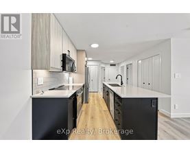 A modern kitchen with wooden cabinets and black appliances.