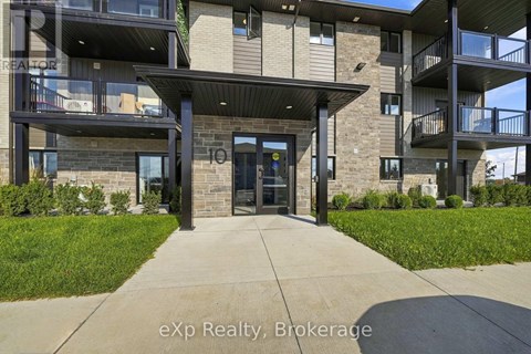 The entrance to a building with a glass door and a balcony.