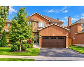 A large, well-maintained house with a brick facade and a large driveway.