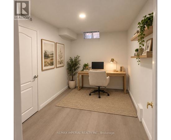 A home office with a desk, chair, and a potted plant.