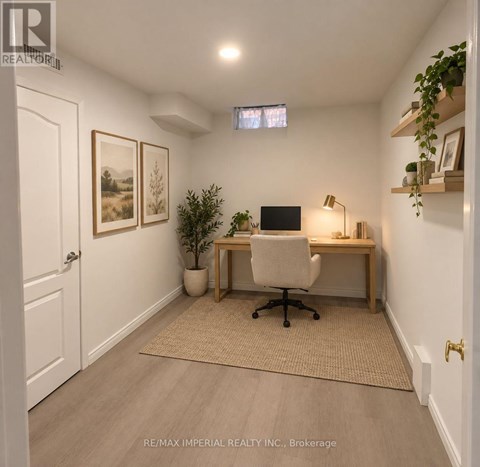 A home office with a desk, chair, and a potted plant.