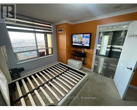 A bedroom with a large bed and a flat screen TV.