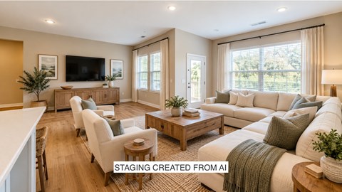 A living room with a television, couch, and chairs.
