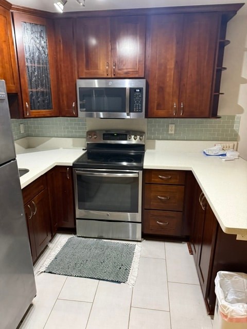 A kitchen with a stove top oven and microwave.