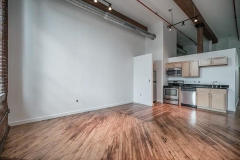 A kitchen area with a stove top oven and microwave.
