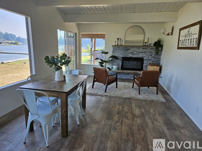 A dining room with a wooden table and chairs.