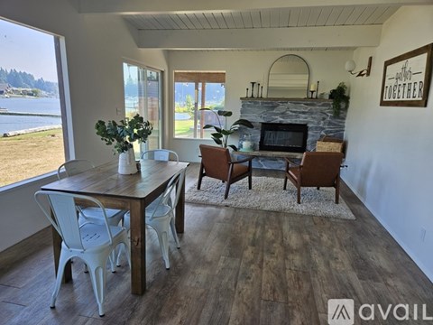 A dining room with a wooden table and chairs.