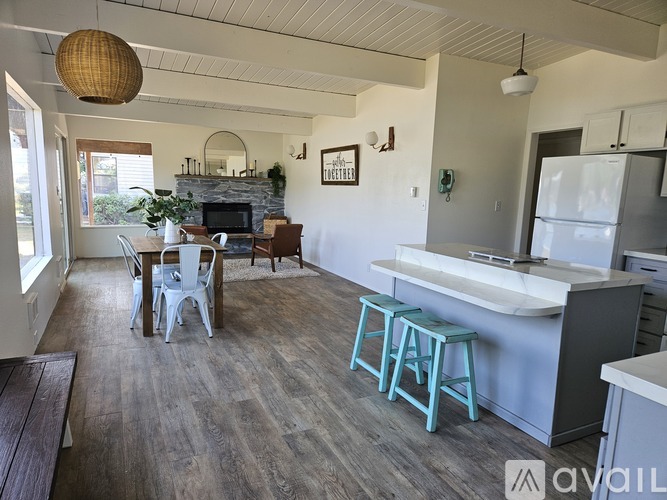 A kitchen with a dining table and chairs.