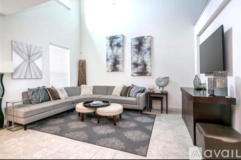 A living room with a grey sofa and a coffee table.