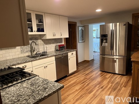 A kitchen with a stove top oven and a refrigerator.