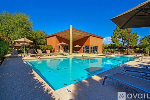 A large outdoor swimming pool with a building in the background.