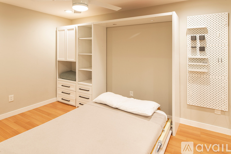 A bedroom with a bed, nightstand, and a closet with shelves.