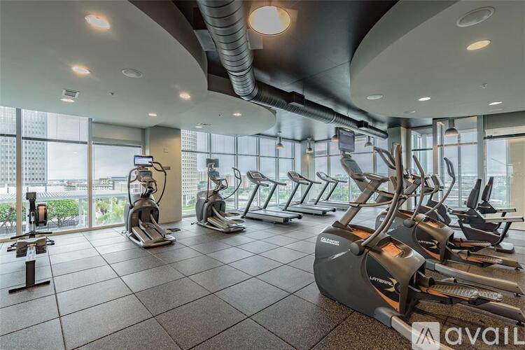 A gym with treadmills, elliptical machines and other cardio equipment.