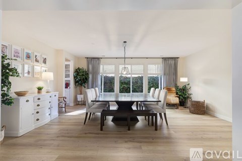 A modern dining room with a large table and chairs.