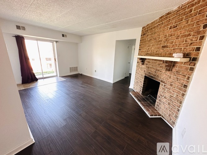 A living room with a fireplace and a large window.