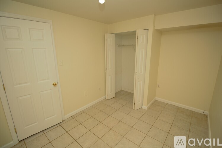 A room with a door and a wall with a doorway.