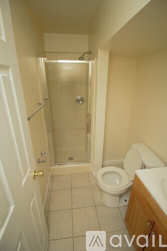A bathroom with a toilet, sink, and shower.