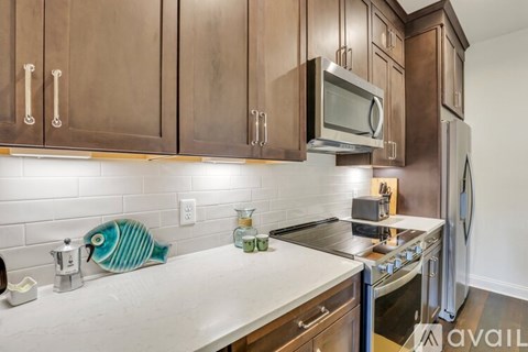 A kitchen with wooden cabinets and a white countertop.