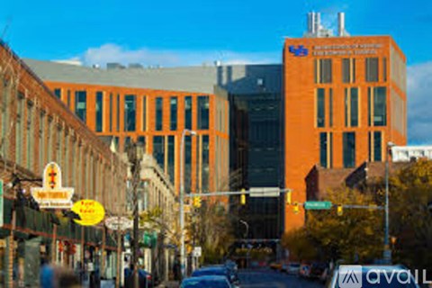 A city street with a car and buildings.