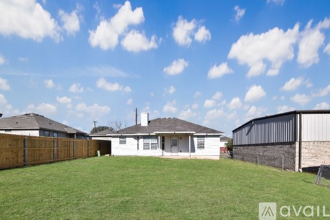 A house with a fence and a grassy yard is for sale.