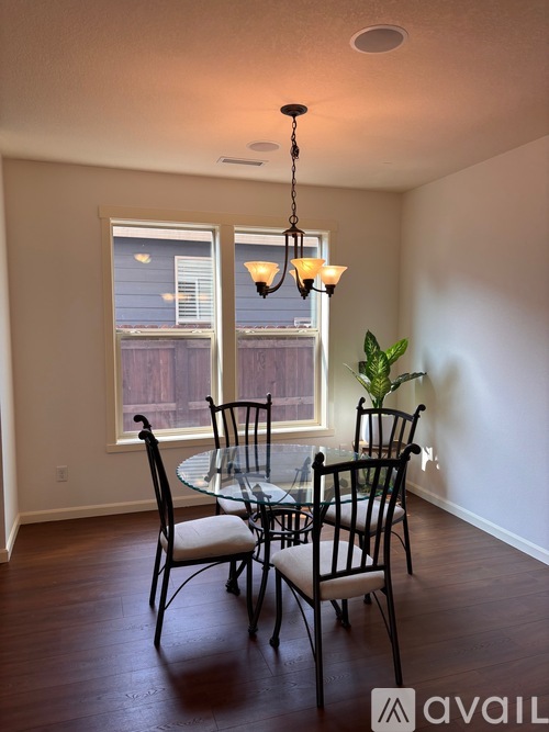 A dining room with a table set for two.
