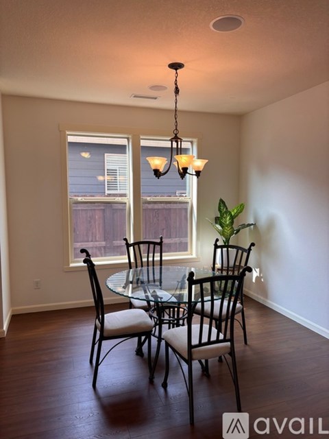A dining room with a table set for two.