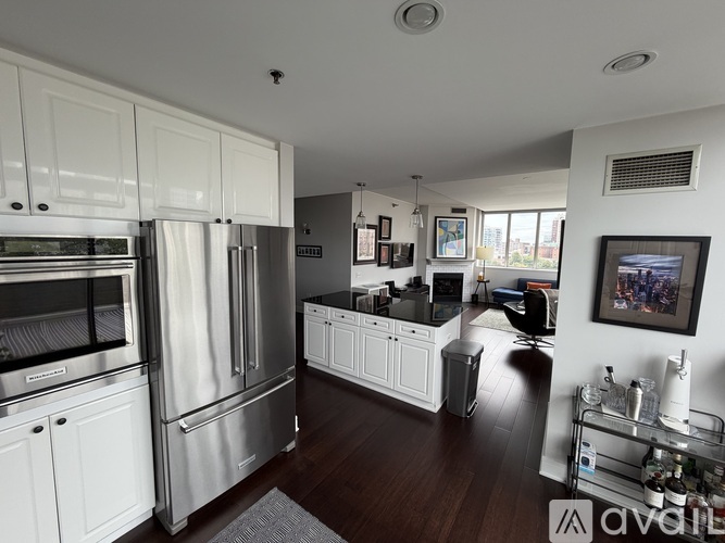 A modern kitchen with stainless steel appliances and white cabinets.